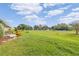 Spacious backyard with grassy area and golf course view at 3942 Trophy Blvd, New Port Richey, FL 34655