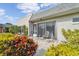 Relaxing patio with seating area, lush landscaping, and sliding glass doors at 3942 Trophy Blvd, New Port Richey, FL 34655