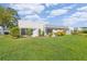 Landscaped backyard with lush grass and a view of the community at 3942 Trophy Blvd, New Port Richey, FL 34655