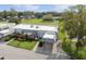 Aerial view showcasing the property, carport, and surrounding landscape at 3942 Trophy Blvd, New Port Richey, FL 34655