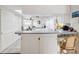 Clean kitchen features white cabinets and breakfast bar at 3942 Trophy Blvd, New Port Richey, FL 34655