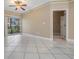 Spacious living room with tile floors, ceiling fan and sliding glass doors to balcony at 4323 Bayside Village Dr # 105, Tampa, FL 33615