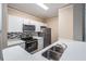 Modern kitchen with white cabinets, stainless steel appliances, and quartz countertops at 4323 Bayside Village Dr # 105, Tampa, FL 33615