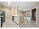 Open concept kitchen with a breakfast bar and view into living room at 4323 Bayside Village Dr # 105, Tampa, FL 33615