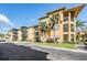 Apartment building with screened balconies and palm trees at 4323 Bayside Village Dr # 105, Tampa, FL 33615