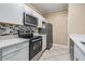 Modern kitchen with white cabinets, stainless steel appliances, and quartz countertops at 4323 Bayside Village Dr # 105, Tampa, FL 33615