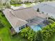 Aerial view of a home with a screened-in pool and jacuzzi surrounded by lush tropical landscaping at 101 Brookover Ln, Brandon, FL 33511