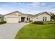 Beautifully landscaped single-story home with a three-car garage and a classic architectural style at 101 Brookover Ln, Brandon, FL 33511