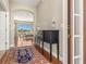 Bright entryway with hardwood floors, a console table, and view of living room at 10527 Old Tampa Bay Dr, San Antonio, FL 33576