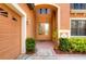 Inviting house entrance with double doors, landscaping, and attached garage at 20103 Shady Hill Ln, Tampa, FL 33647