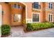 Front entrance with double doors, brick walkway, and lush green landscaping at 20103 Shady Hill Ln, Tampa, FL 33647