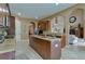 Open kitchen with island, granite countertops, and views to Gathering room at 20103 Shady Hill Ln, Tampa, FL 33647