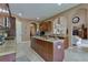 Open kitchen with island, granite countertops, and views to Gathering room at 20103 Shady Hill Ln, Tampa, FL 33647
