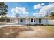 Light blue house with carport and a well maintained lawn at 2484 Bayshore Blvd, Dunedin, FL 34698