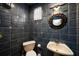 Small bathroom with blue tile, pedestal sink, and toilet at 3120 Beach S Blvd # 7, Gulfport, FL 33707