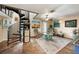 Living room with spiral staircase and stone floors at 3120 Beach S Blvd # 7, Gulfport, FL 33707