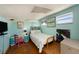 Cozy bedroom with a starfish quilt and wood floors at 3120 Beach S Blvd # 7, Gulfport, FL 33707