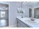 Bathroom featuring double sinks, a large mirror, and ample counter space at 5103 Ashcrest Ct, Tampa, FL 33647