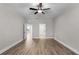 Spacious bedroom featuring wood-look floors and access to an ensuite bathroom and closet at 5479 Brussels Ter, Port Charlotte, FL 33981