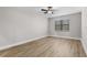 Comfortable bedroom with wood-look flooring, a ceiling fan, and bright natural light at 5479 Brussels Ter, Port Charlotte, FL 33981