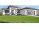 Inviting single-story home with lush green lawn, elegant entryway, and attached gray two-car garage at 5479 Brussels Ter, Port Charlotte, FL 33981