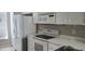 Kitchen with white appliances and cabinets at 6212 Bayside Key Dr, Tampa, FL 33615