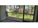 View of backyard through screened porch at 6212 Bayside Key Dr, Tampa, FL 33615