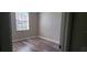 Simple bedroom with wood-look floors and window at 6212 Bayside Key Dr, Tampa, FL 33615