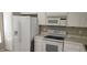 Kitchen with white appliances and cabinets at 6212 Bayside Key Dr, Tampa, FL 33615