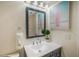 Stylish bathroom with vanity, mirror, and surfboard art at 6372 Palma Del Mar S Blvd # 320, St Petersburg, FL 33715