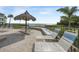 White lounge chairs await by the pool with an ocean view at 6372 Palma Del Mar S Blvd # 320, St Petersburg, FL 33715