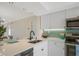 Modern kitchen with white cabinets, stainless steel appliances, and a stylish backsplash at 6372 Palma Del Mar S Blvd # 320, St Petersburg, FL 33715