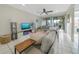 Spacious living room with sectional sofa, fireplace, and access to balcony at 6372 Palma Del Mar S Blvd # 320, St Petersburg, FL 33715