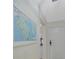 Bright entryway with a map print and white door at 6372 Palma Del Mar S Blvd # 320, St Petersburg, FL 33715