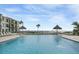 Inviting community pool overlooking the water with plenty of lounge chairs at 6372 Palma Del Mar S Blvd # 320, St Petersburg, FL 33715