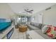 Living room with sectional sofa and a view to the balcony at 6372 Palma Del Mar S Blvd # 320, St Petersburg, FL 33715