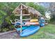 Outdoor Kayak storage area with thatched roof covering at 6372 Palma Del Mar S Blvd # 320, St Petersburg, FL 33715