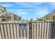 Gated pool area with lounge chairs, tiki huts, and a notice for 24-hour video surveillance at 6372 Palma Del Mar S Blvd # 320, St Petersburg, FL 33715