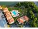 Aerial view of a community with pool, lush landscaping, and waterfront access at 6372 Palma Del Mar S Blvd # 320, St Petersburg, FL 33715