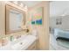 Bathroom vanity with a mirror and decorative orchids at 6372 Palma Del Mar S Blvd # 320, St Petersburg, FL 33715