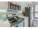 Kitchen features stainless steel appliances and light teal backsplash at 6372 Palma Del Mar S Blvd # 320, St Petersburg, FL 33715