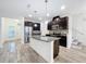 Modern kitchen with dark cabinetry, granite countertops and island at 9224 Fox Sparrow Rd, Tampa, FL 33626