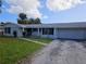 House front view, featuring a brick facade and a large grassy lawn at 4354 50Th S Ter, St Petersburg, FL 33711
