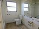 Bathroom with toilet, bathtub, and a large mirror needs updating at 4354 50Th S Ter, St Petersburg, FL 33711