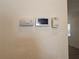 Wall-mounted thermostat, carbon monoxide detector, and electrical panel at 469 80Th Way, St Pete Beach, FL 33706