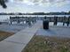 Wooden fishing pier with water access, trash receptacle, and scenic views at 469 80Th Way, St Pete Beach, FL 33706
