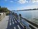 Wooden pier extends over calm water under a bright sky at 469 80Th Way, St Pete Beach, FL 33706