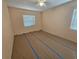 Simple bedroom with vinyl flooring, window with blinds and ceiling fan at 469 80Th Way, St Pete Beach, FL 33706