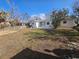 View of the home's backyard, showing a grassy area and patio at 469 80Th Way, St Pete Beach, FL 33706