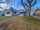 Front view of a single-story house with a yard and palm trees at 469 80Th Way, St Pete Beach, FL 33706